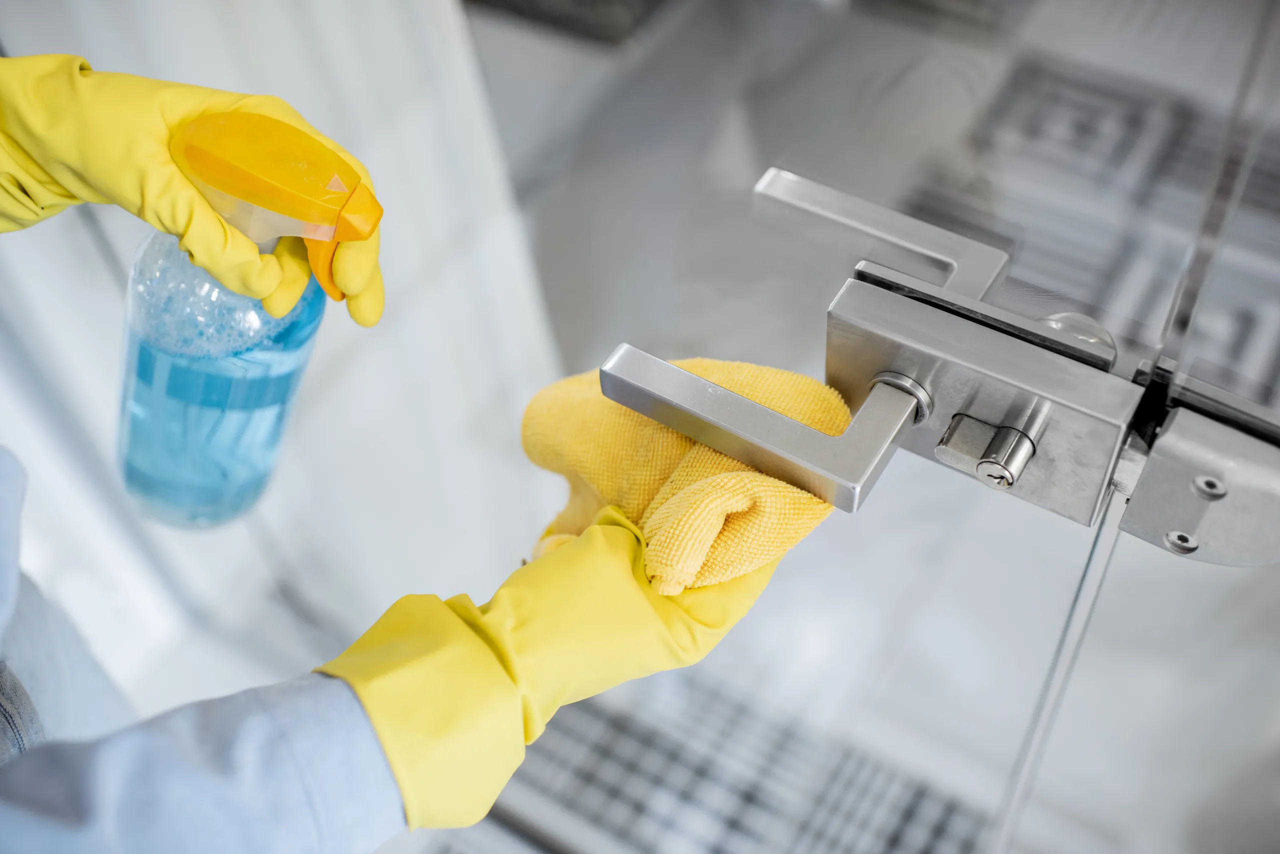 Woman cleaning door handle at home done right cleaning scaled